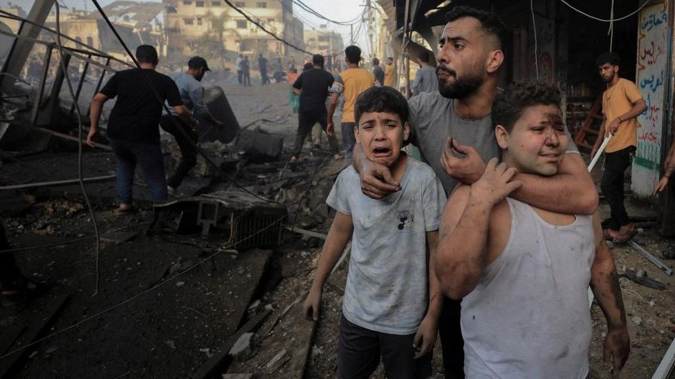 Palestinians react after an air strike in Gaza City (file photo)