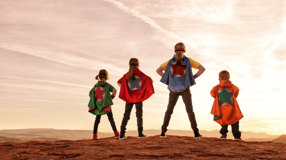 Siblings dressed as superheroes
