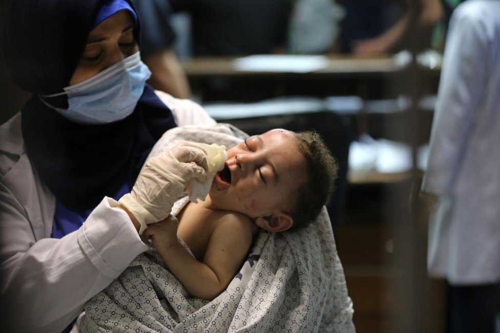 A baby injured in Israeli attack carried out to home of Palestinian Abu Khatab Family living in Al-Shati Camp in Gaza Strip, being brought to Shifa Hospital on May 15, 2021, in Gaza City, Gaza