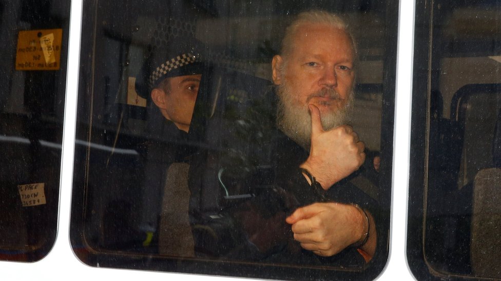 Julian Assange pictured in a police van