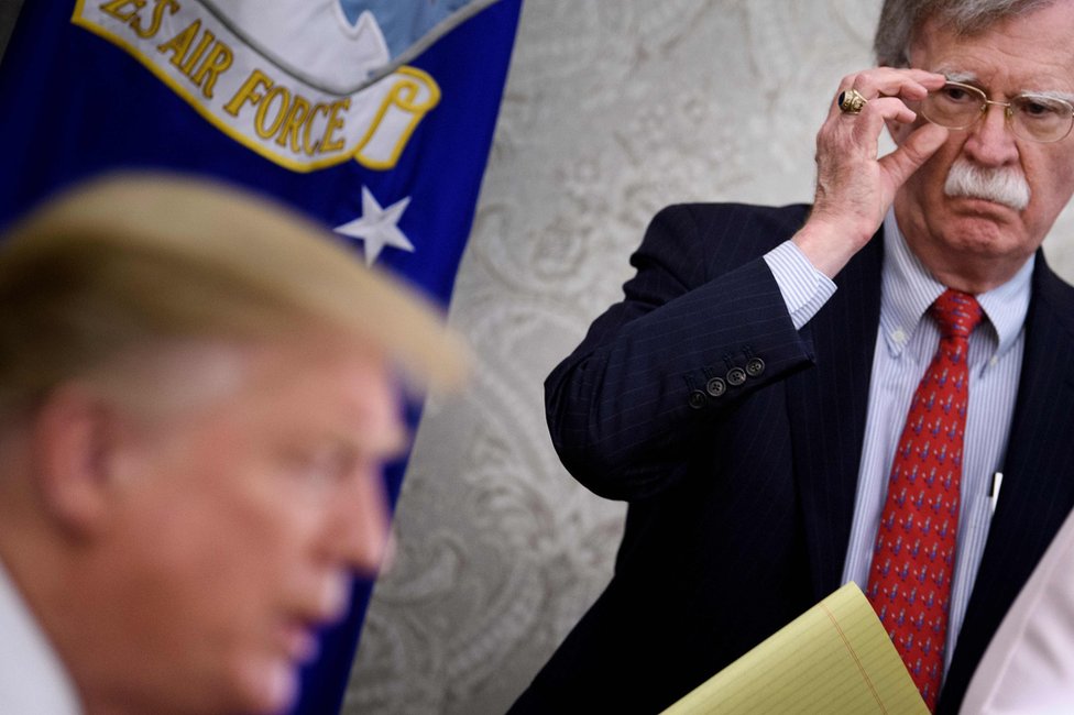 National Security Adviser John Bolton listens while President Donald Trump speaks at the White House on 13 May 2019