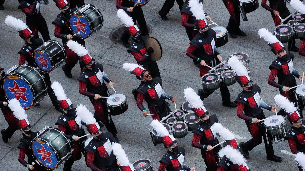 A marching band parades through Manhattan for Thanksgiving