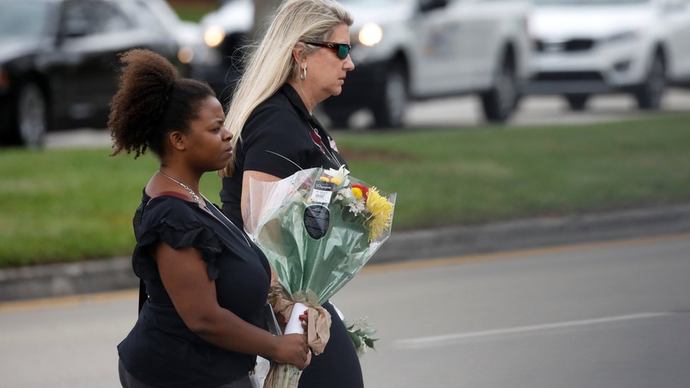 Mourners at a funeral for one of the victims