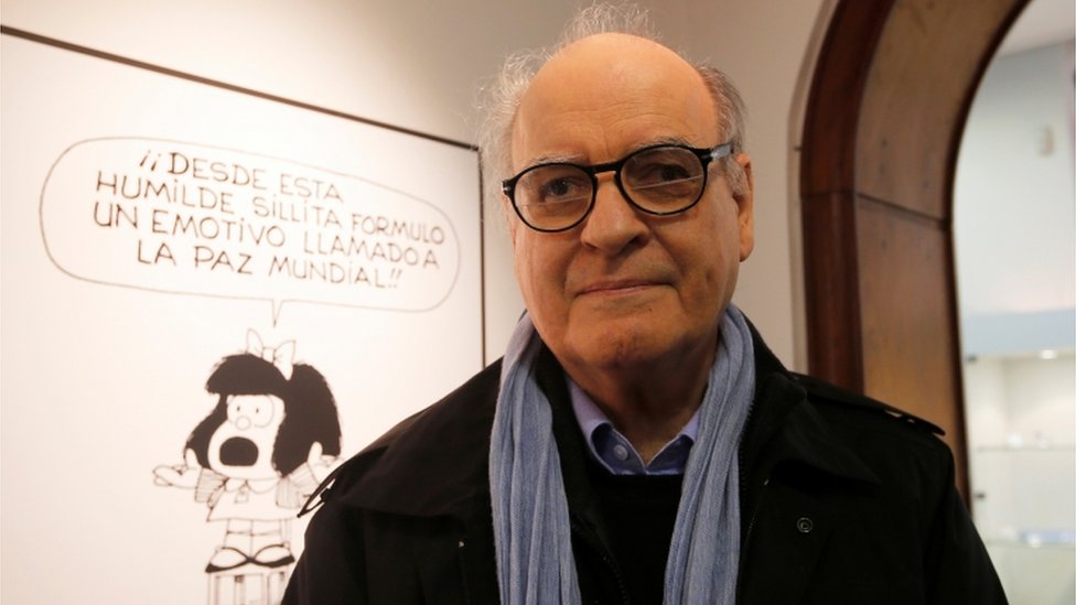 Argentine cartoonist Joaquin Lavado, also known by his pen name Quino, poses in front of an image of his most famous comic character Mafalda during the opening ceremony of the exhibition of his works at the Museo del Humor in Buenos Aires June 14, 2014