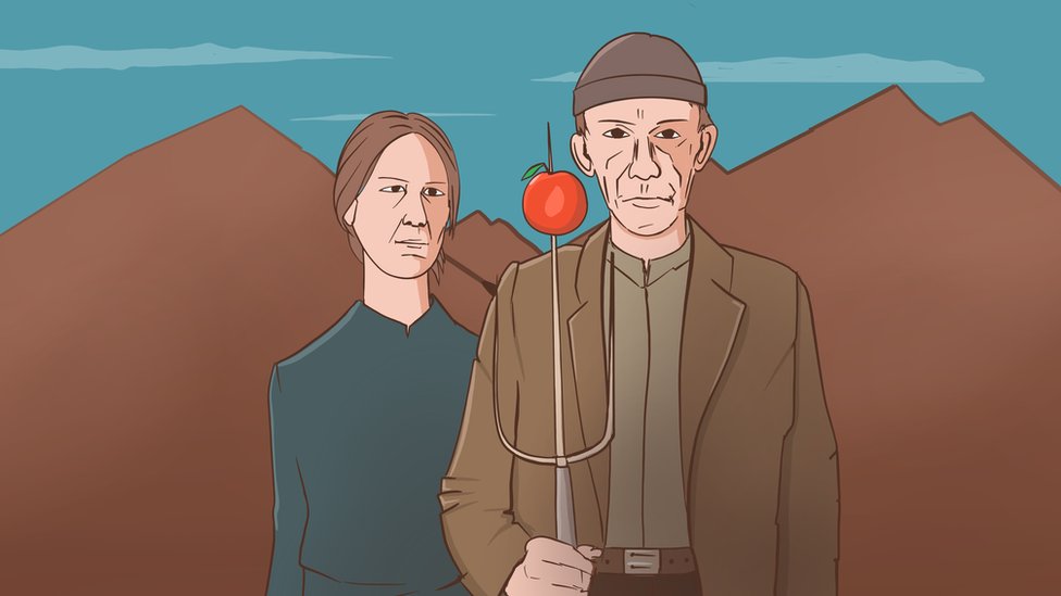 Žena i muškarac stoje sa crvenom jabukom