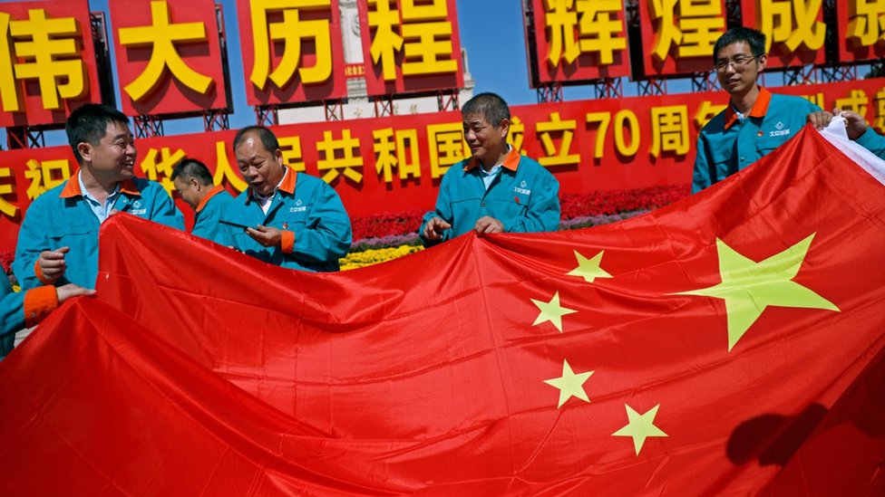 Chinese workers with Chinese flag