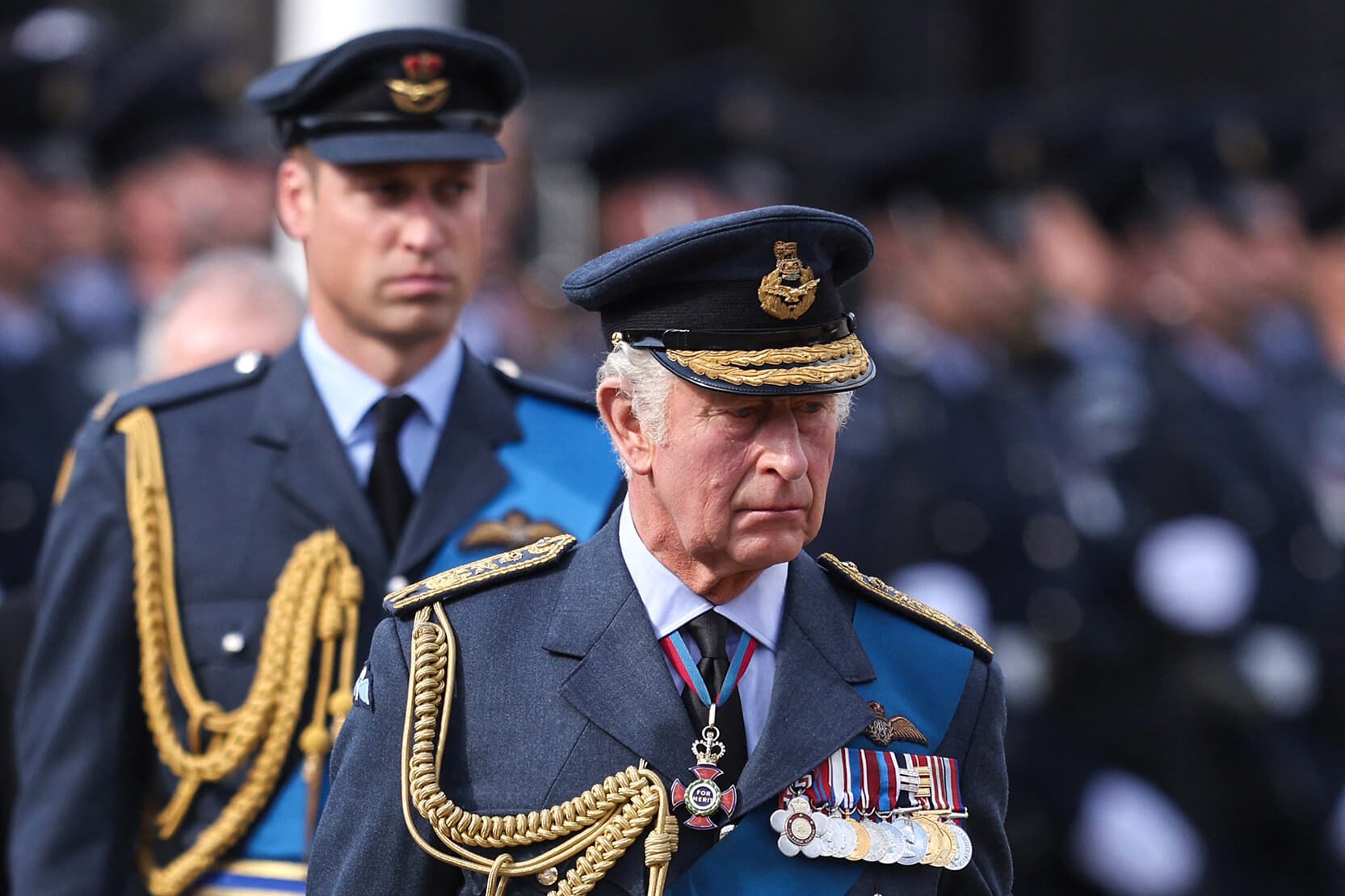 King Charles III and Prince William walk behind the Queen's coffin