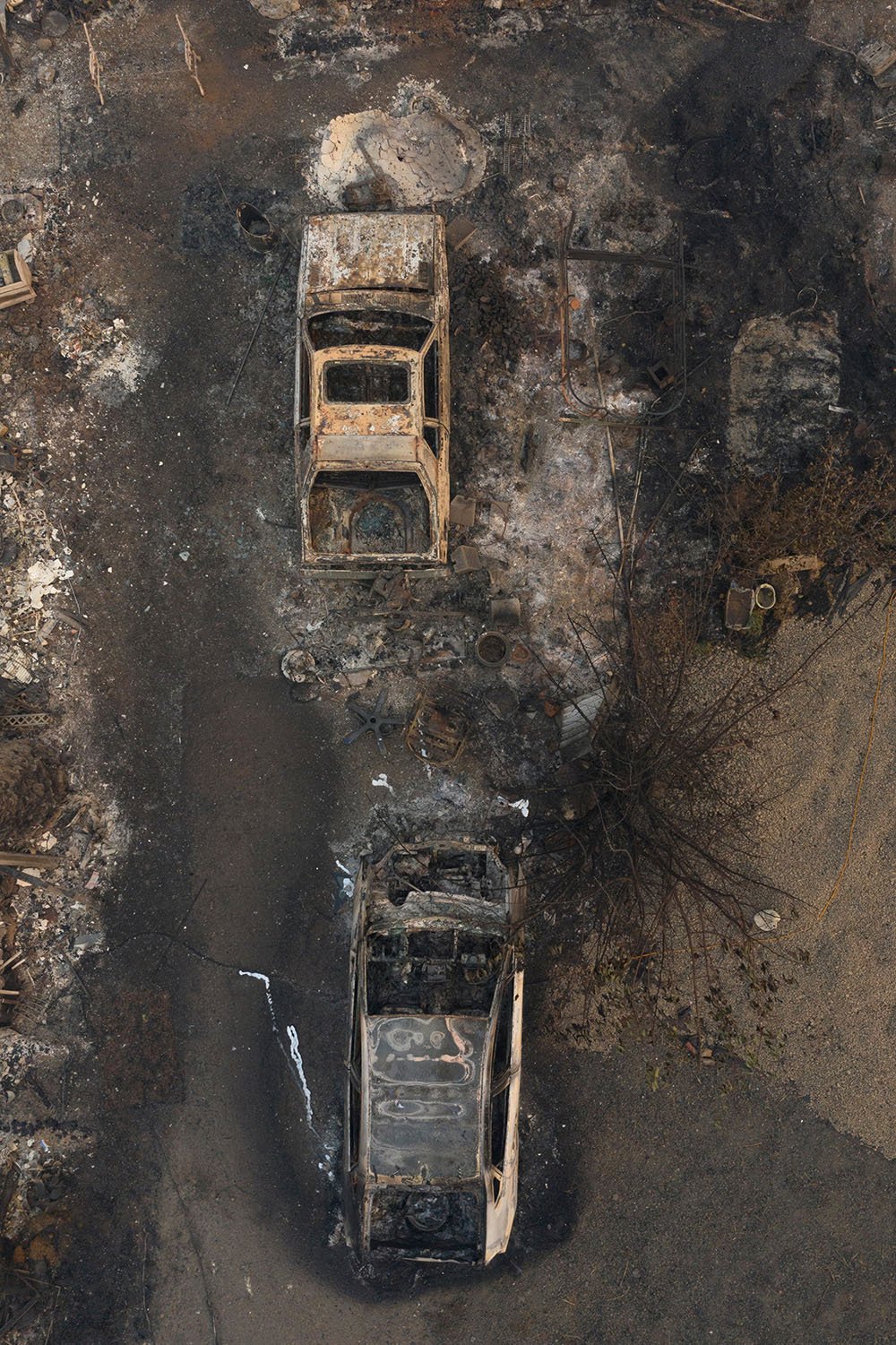 Destroyed cars are seen as the aftermath of the South Obenchain Fire along Butte Falls Highway in Eagle Point, Oregon