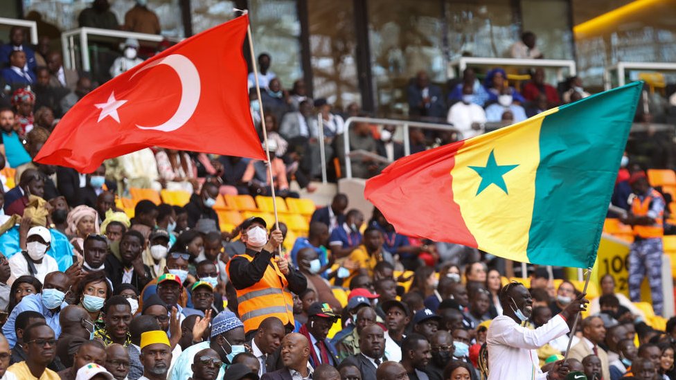 جماهير سنغالية ترفع العلمين التركي والسنغالي عند افتتاح الملعب الجديد في داكار.
