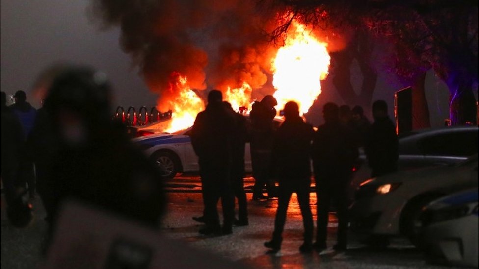 A burning police car during a protest.