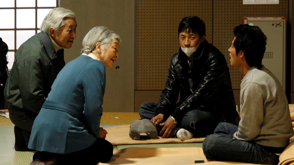 Japan's Emperor Akihito and Empress Michiko talk with evacuees from the March 11 earthquake and tsunami at Tokyo Budoh-kan