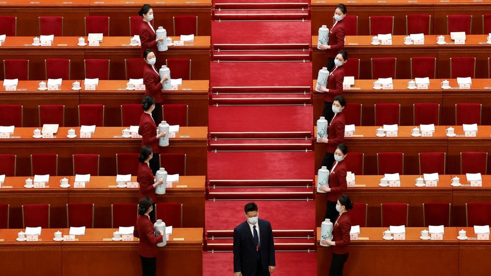 Staff members prepare before the opening session of the National People"s Congress (NPC) at the Great Hall of the People in Beijing, China March 5, 2023.