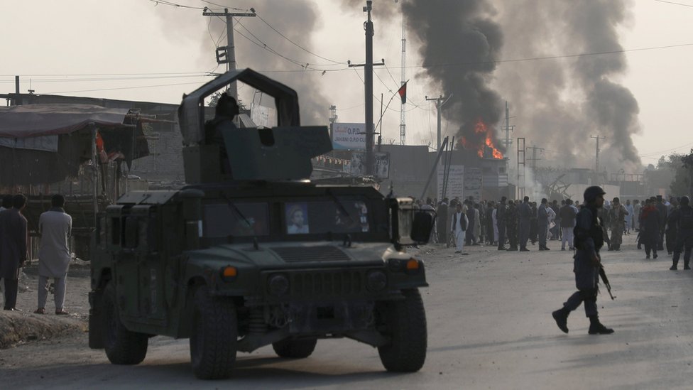 Policemen keep watch as angry Afghan protesters burn tires and shout slogans at the site of a blast in Kabul, Afghanistan September 3, 2019