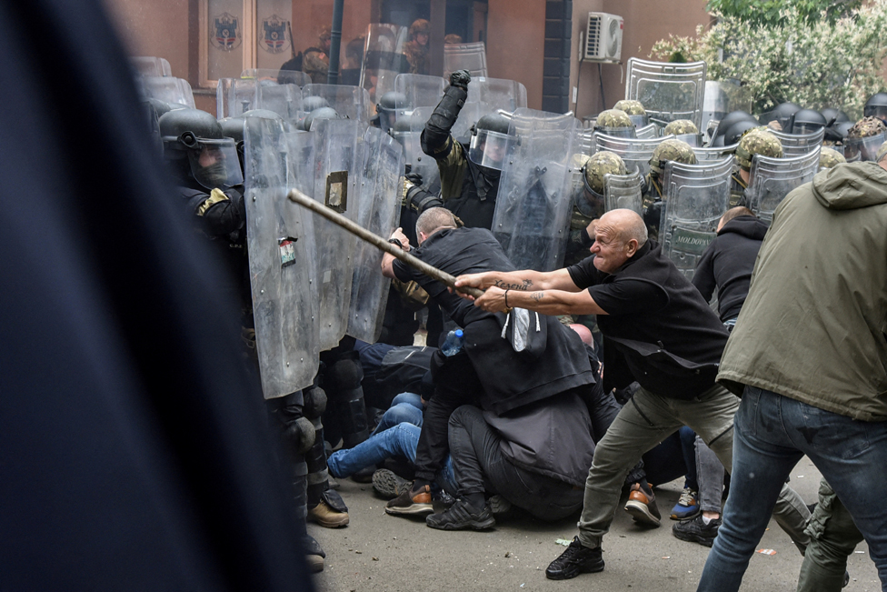 قوات حلف شمال الأطلسي (KFOR) يشتبكون مع متظاهرين محليين من صرب كوسوفو عند مدخل مكتب البلدية، في بلدة زفيكان، كوسوفو، 29 مايو/ أيار 2023.