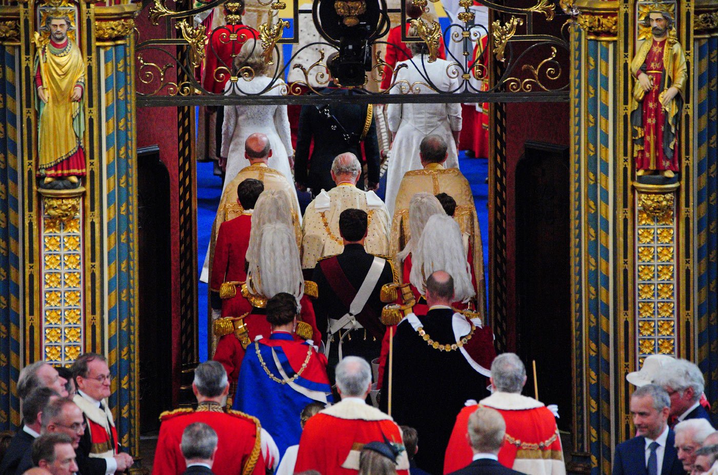 King Charles III walks through the entrance to Westminster Abbey