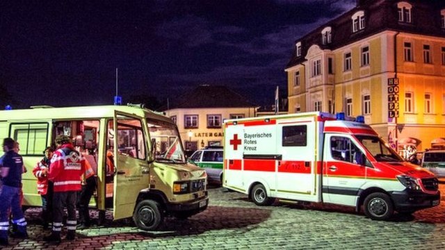Emergency services are seen near a scene of a suicide attack in the southern German city of Ansbach