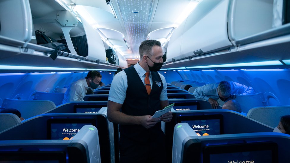 美國紐約肯尼迪國際機場一架捷藍航空往英國倫敦航班上空勤人員與乘客交談（11/8/2021）