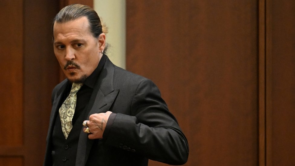 Johnny Depp whistles after testifying in his defence