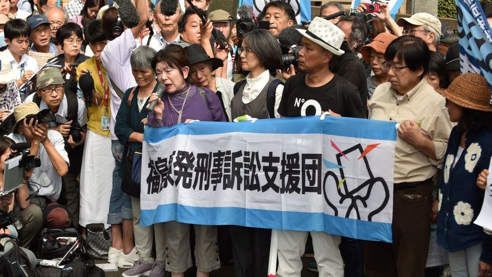 Activists outside a court in Tokyo following the trial of three Tepco executives over the Fukushima disaster 2019
