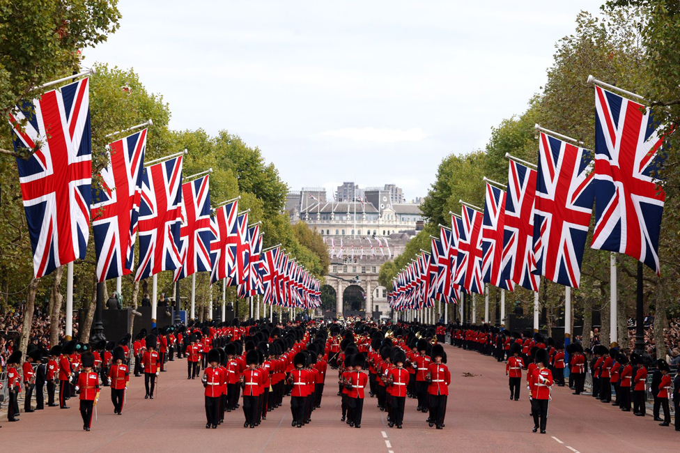 The Grenadier Guards march up The Mall.