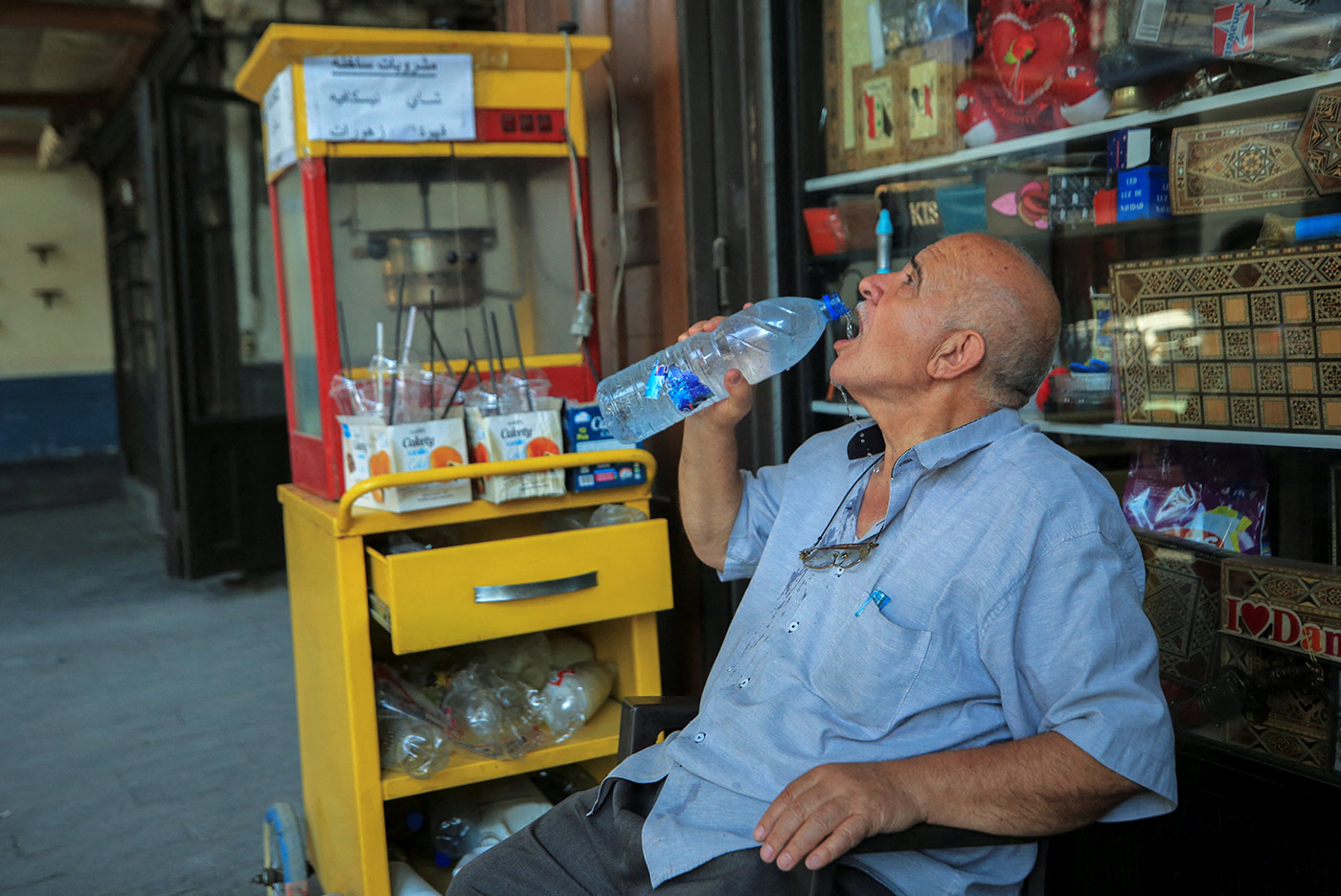 ​​A vendor drinks water during a heatwave, in Damascus, Syria - 17 July 2023