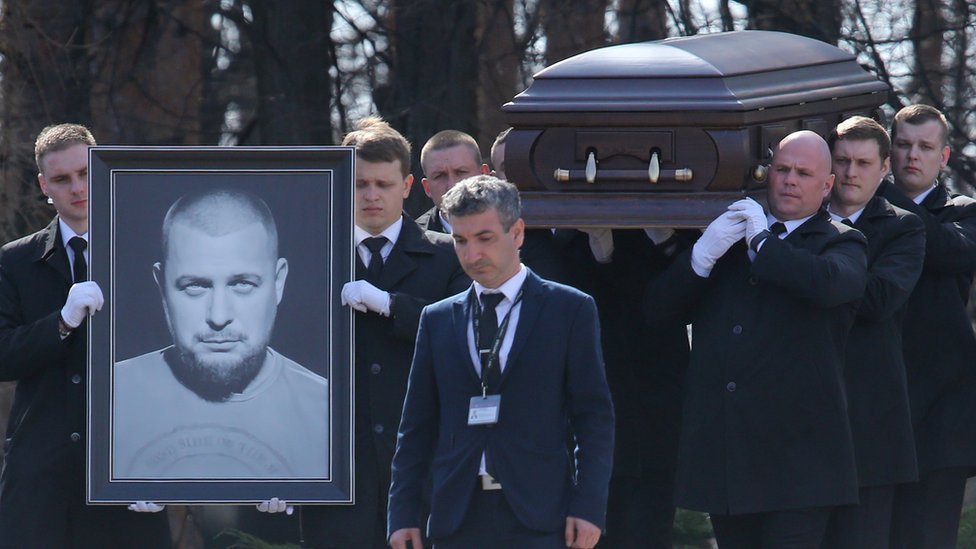 People attend the funeral of Russian military blogger Maxim Fomin, widely known by the name of Vladlen Tatarsky, at Troyekurovo Cemetery on April 8, 2023, in Moscow, Russia