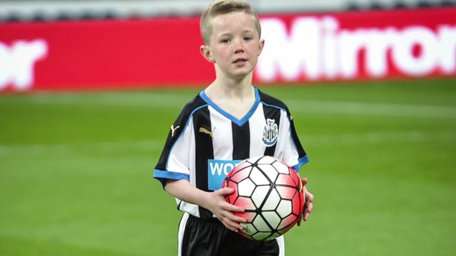 Tyler in on the pitch as a Newcastle United mascot