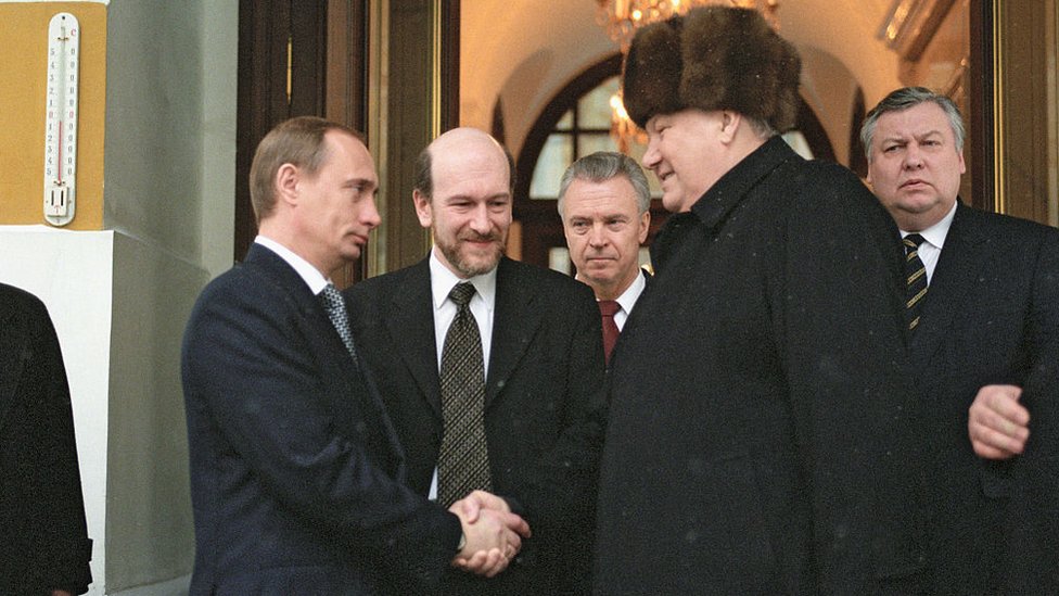 Putin shaking hands with Boris Yeltsin