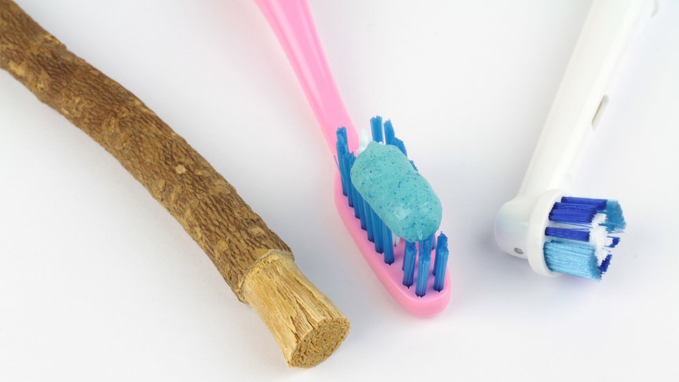 A miswak, toothbrush and electric toothbrush