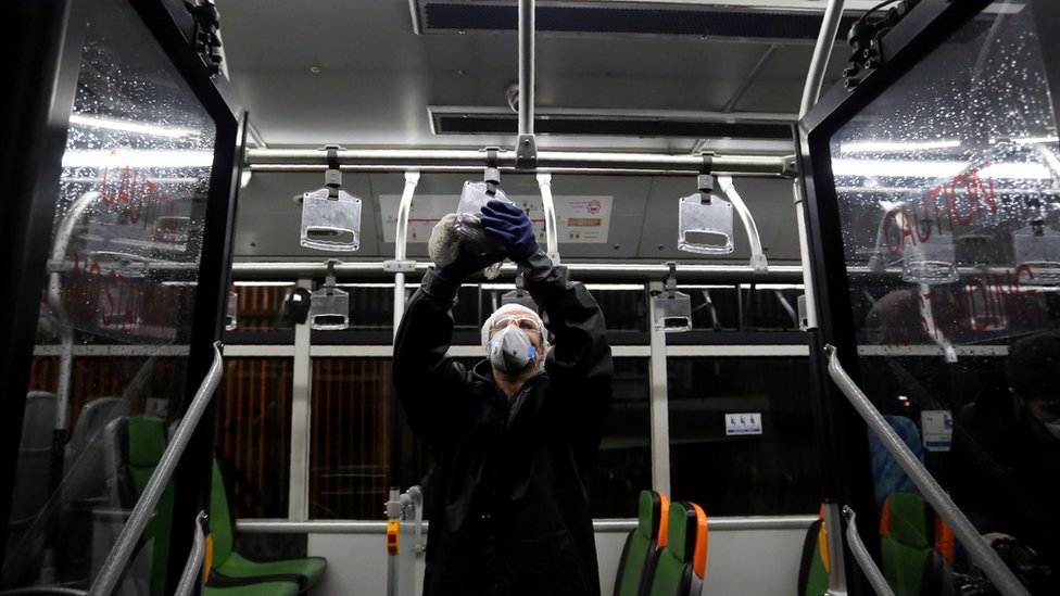 A worker cleans a bus in Teheran in an attempt to prevent the spread of the novel coronavirus