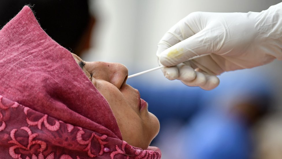 Woman in India gets a swab test