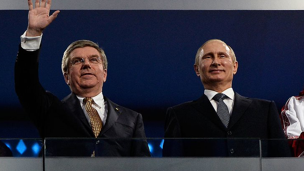 IOC president Thomas Bach (left) waves to the crowd alongside Russian president Vladimir Putin during the Sochi Winter Olympics in 2014