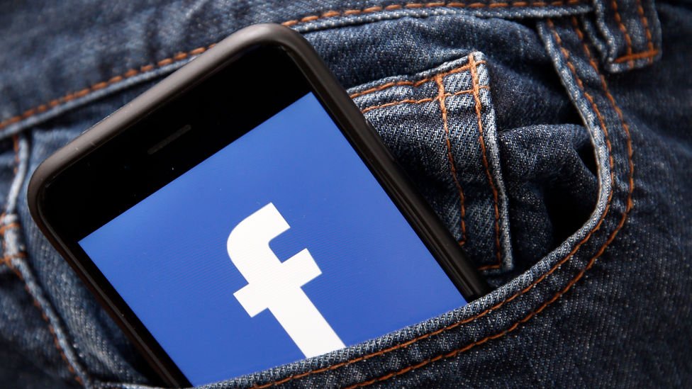 Phone with Facebook logo in pocket
