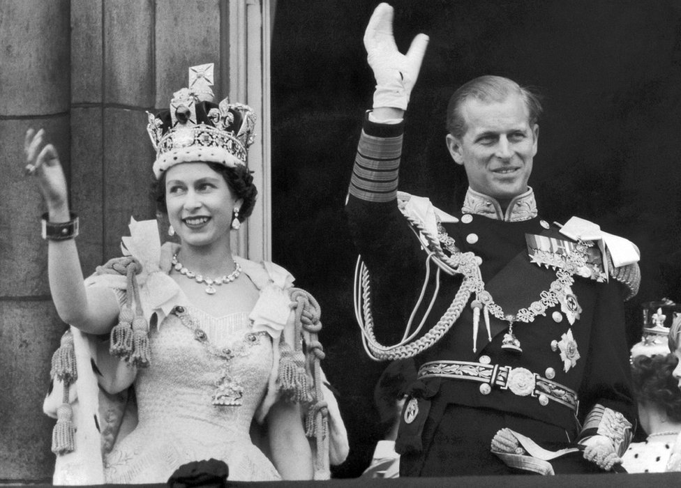 The Queen and the Duke of EDINBURGH wave from the famous balcony at Buckingham Palace to the vast crowds massed outside the Palace on June 2 1953