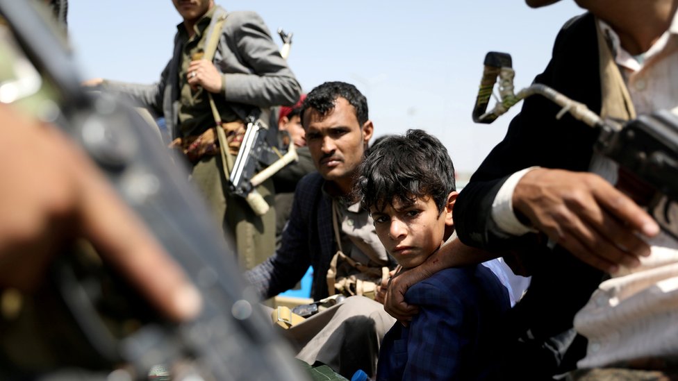 A boy rides with Houthi supporters in a vehicle during a funeral in Sanaa, Yemen (22 September 2020)