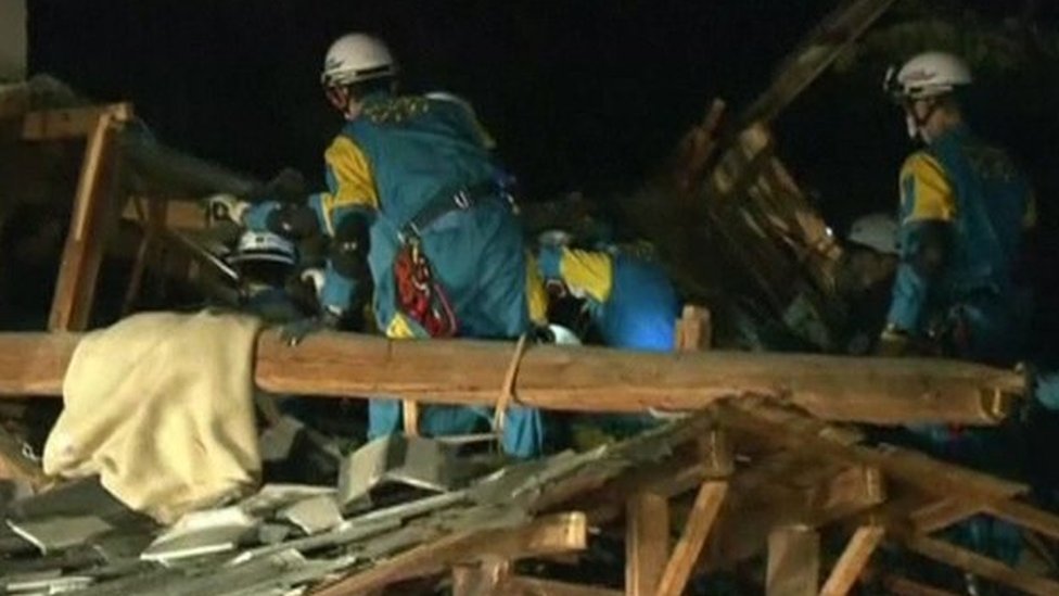 Rescuers search collapsed buildings in Kumamoto