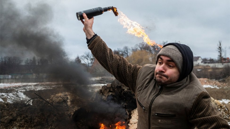 A civilian in Ukraine training in how to throw a Molotov cocktail