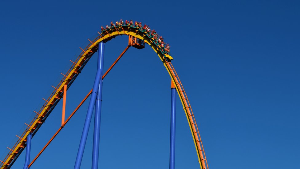 Carriage about to fall down steep drop on rollercoaster