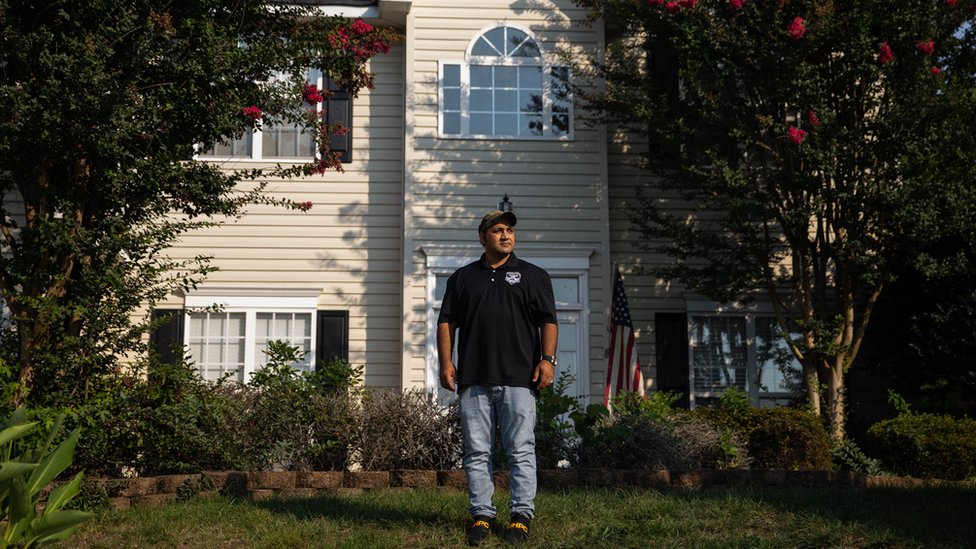 Zia Ghafoori stands in front of his home in North Carolina