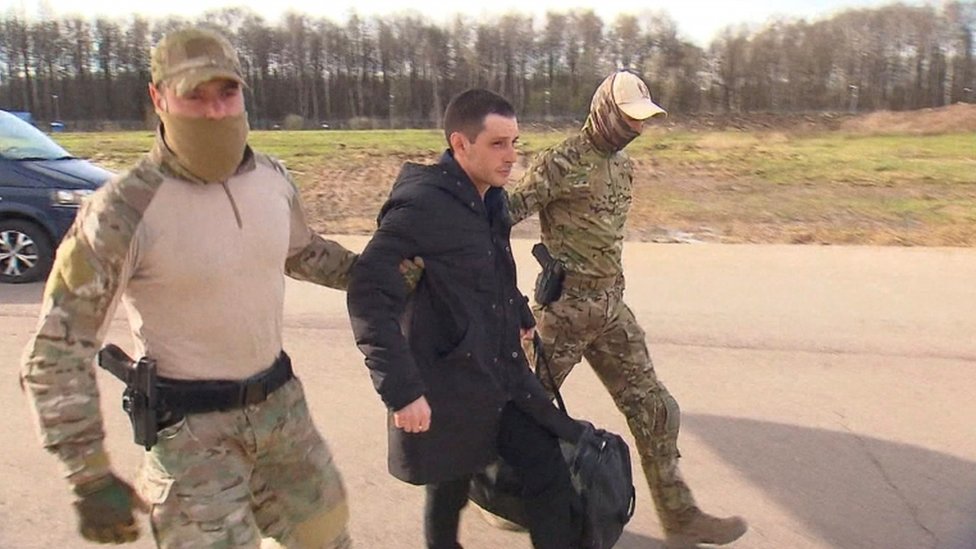 Trevor Reed being escorted to the plane out of Russia on Wednesday