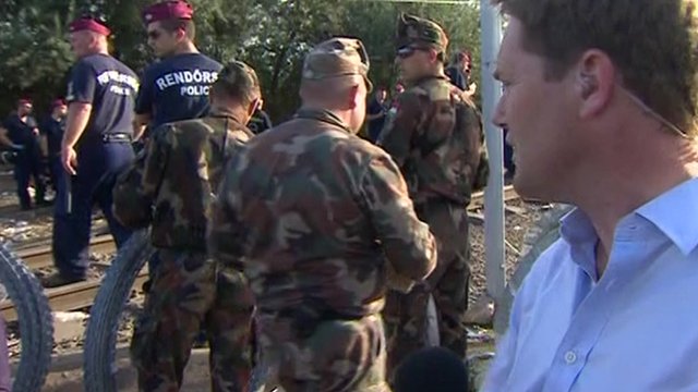 BBC reporter Christian Fraser reporting as Hungarian police work to put up wire at a stretch of the Hungarian border with Serbia