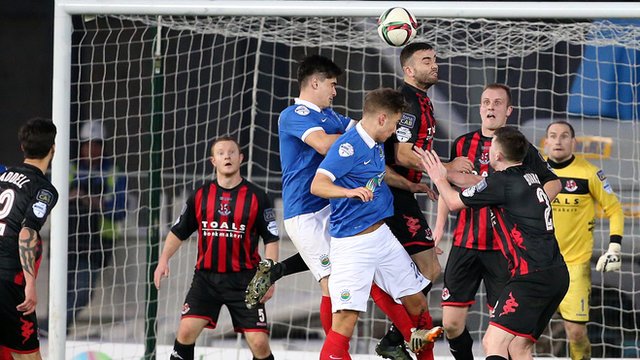 Colin Coates rises highest to head clear as Linfield attack