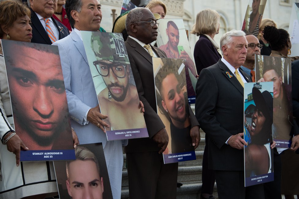 Члены и сторонники Конгресса США по вопросам равенства ЛГБТ держат фотографии жертв теракта в ночном клубе Pulse в Орландо, на ступенях Восточного дома Капитолия США в Вашингтоне, округ Колумбия, 12 июля
