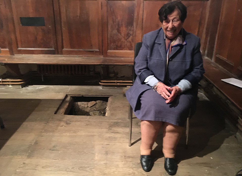 Annie next to the floorboard in the chapel
