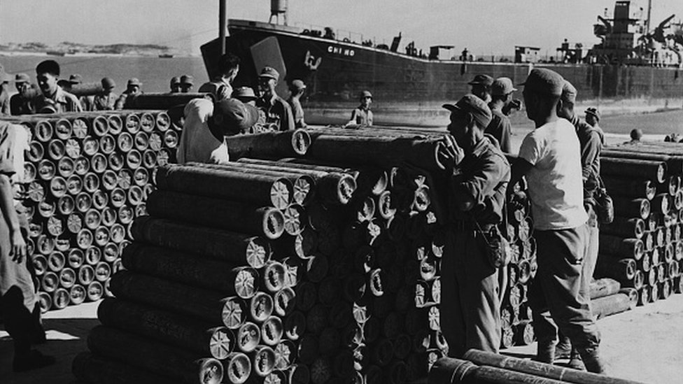 Soldiers stack artillery shells at the seaport on Quemoy to defend against communist Chinese aggression
