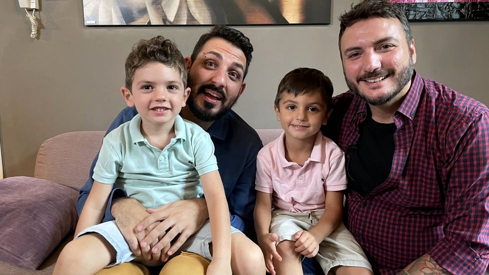 Carlo (2nd from L) with husband Christian (R) and their two children