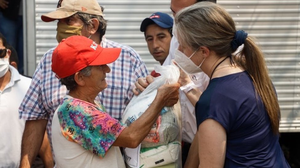 Relatives of former Paraguayan vice president Oscar Denis deliver food in Concepcion, Paraguay, 13 September 2020.