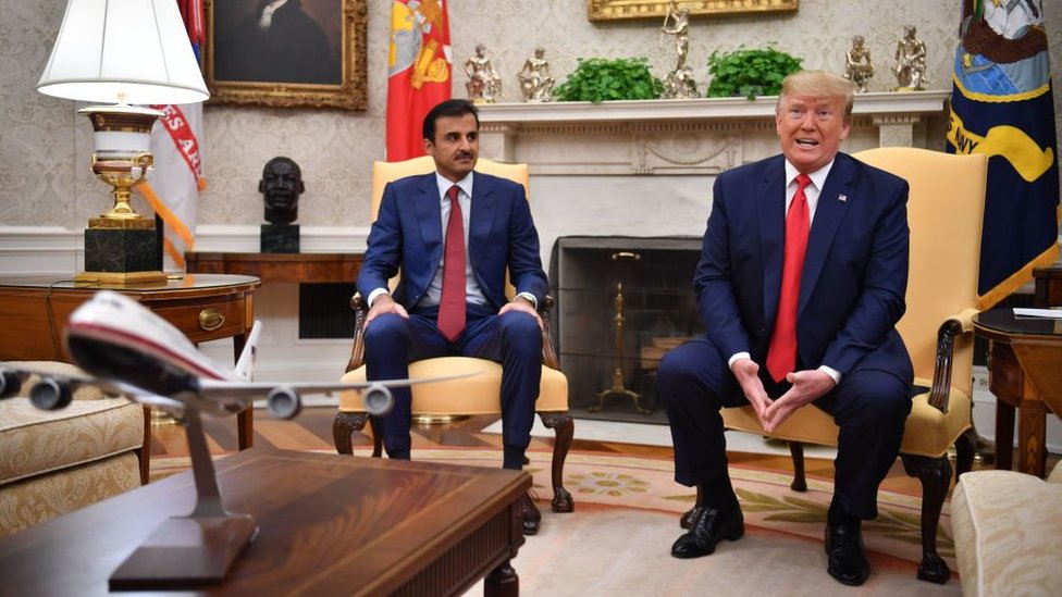 Donald Trump (R) speaks at a meeting with Qatar's Emir Sheikh Tamim bin Hamad Al Thani