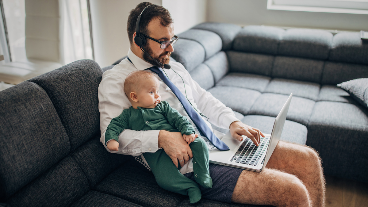 Man working from home - holding a baby