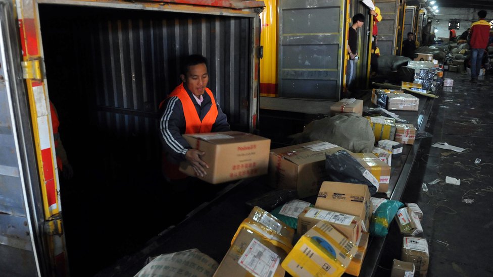 Workers sorting parcels at express delivery company in Beijing